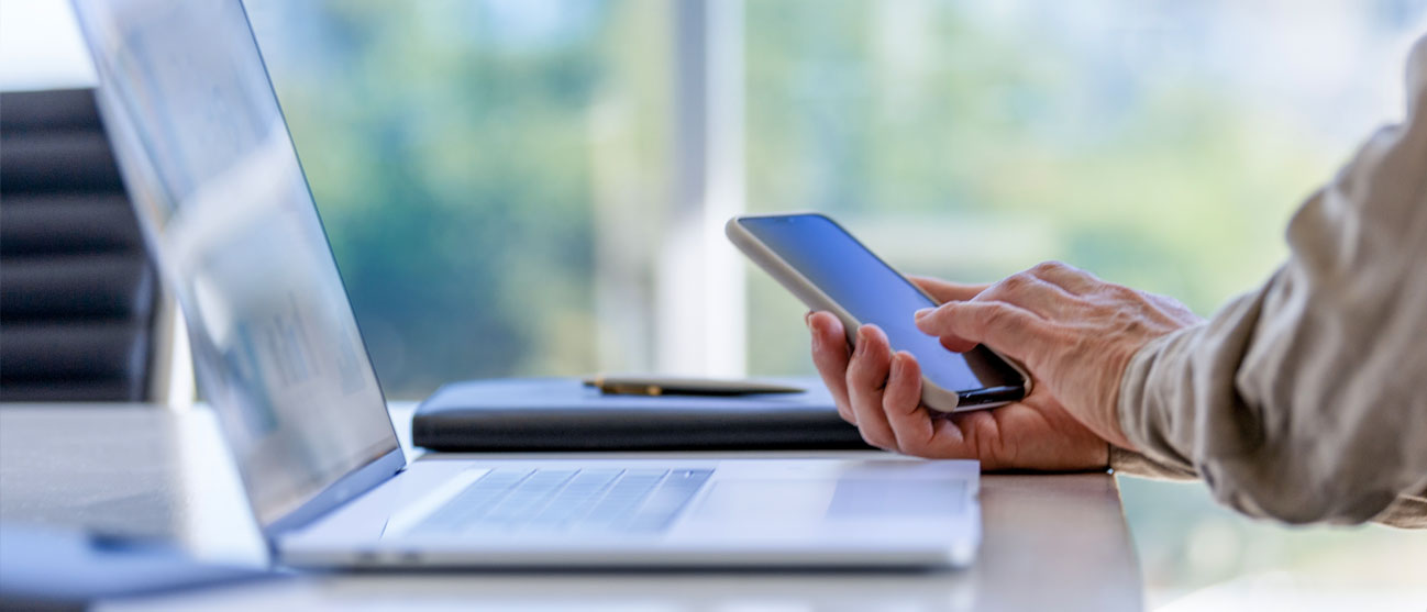 Photo of a man working on a smart phone